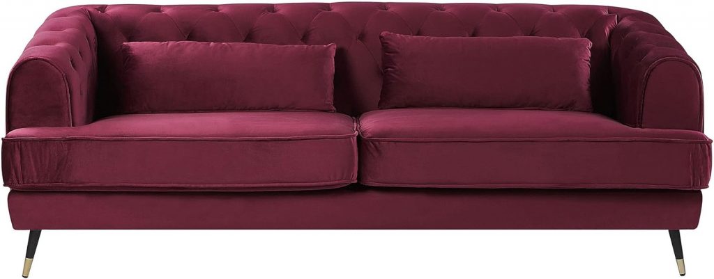 Divano Chesterfield in velluto bordeaux per living moderno tendenze 2026