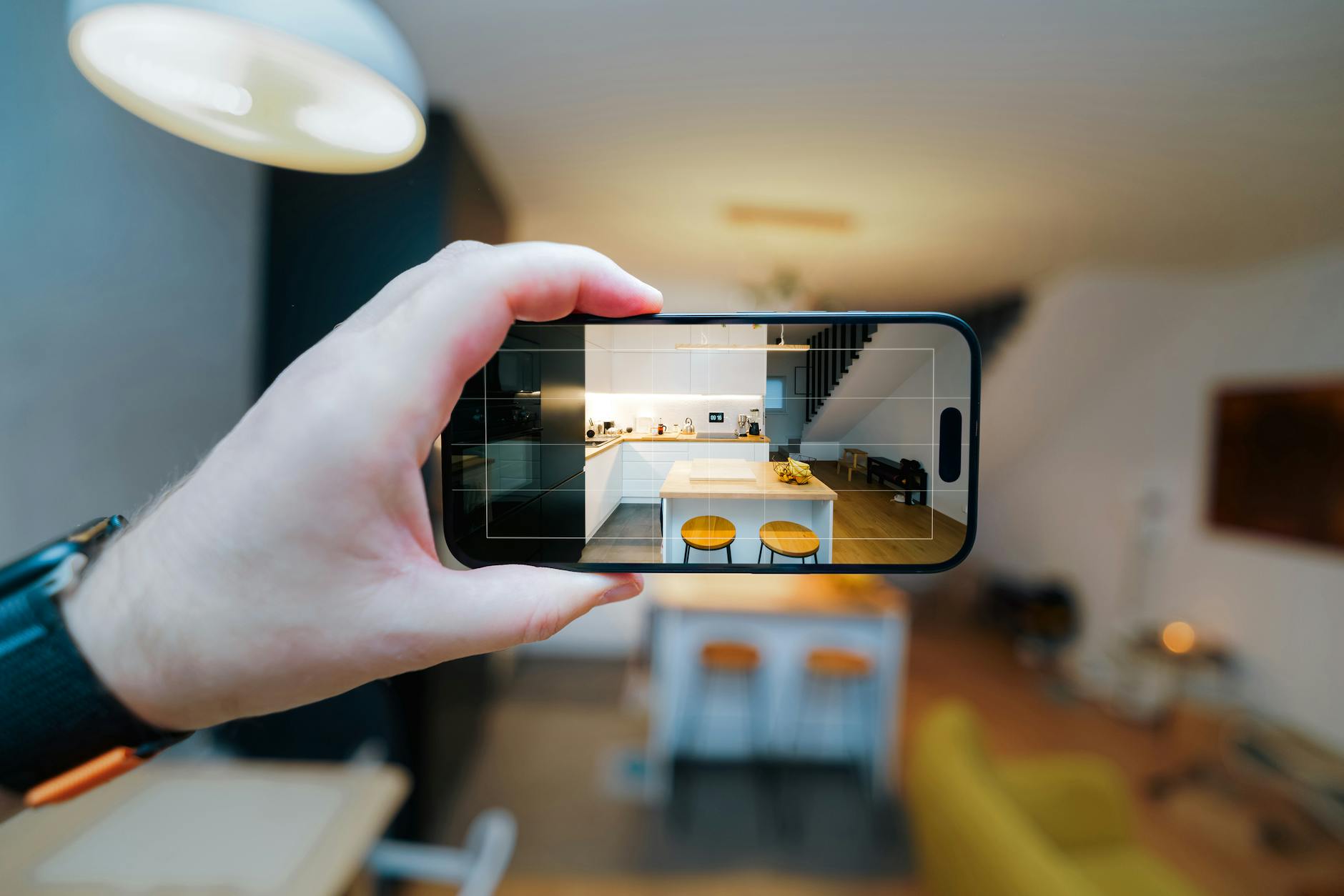 smartphone capturing modern kitchen interior